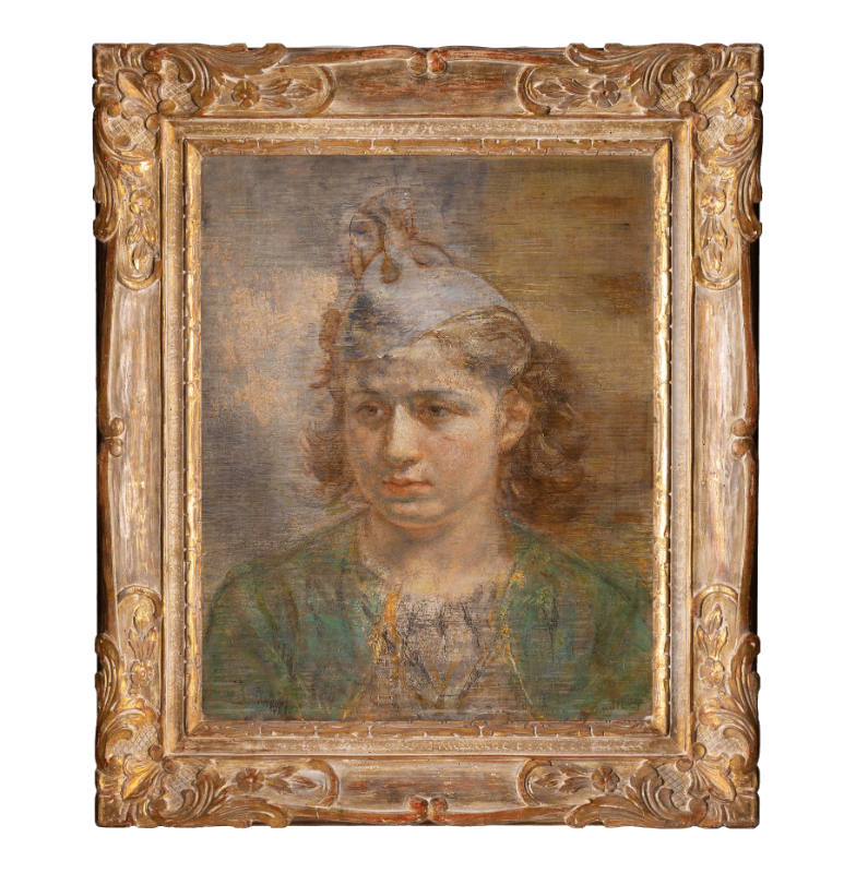 Portrait of a girl with a solemn face wearing a blue hat and green jacket.