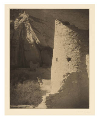 Greyscale photograph of a damaged, brick structure in a cave
